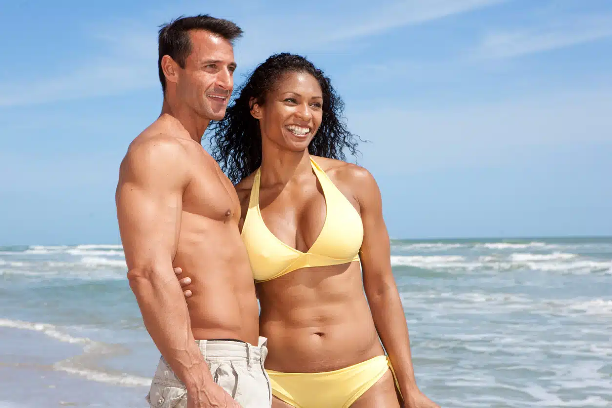 Slim couple on the beach.