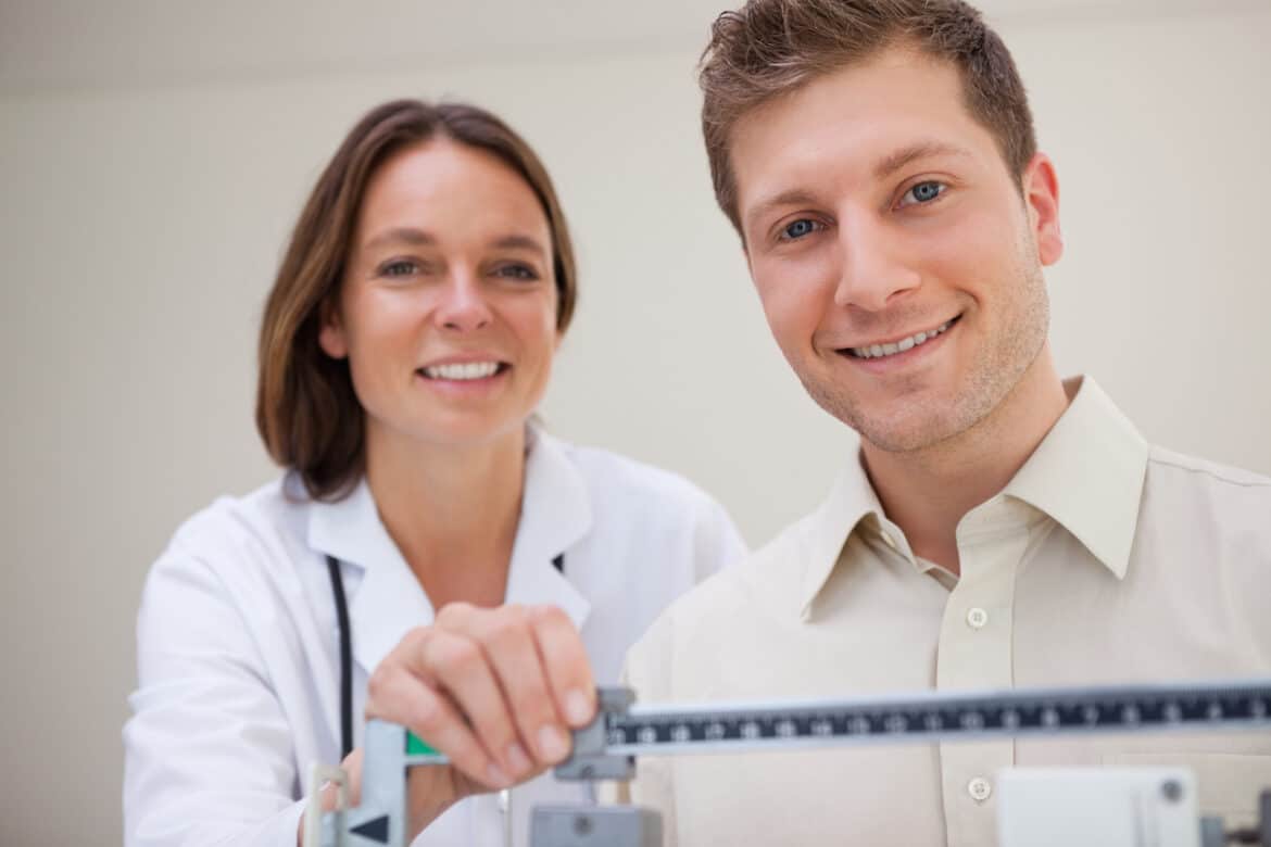 Patient getting scale adjusted by doctor